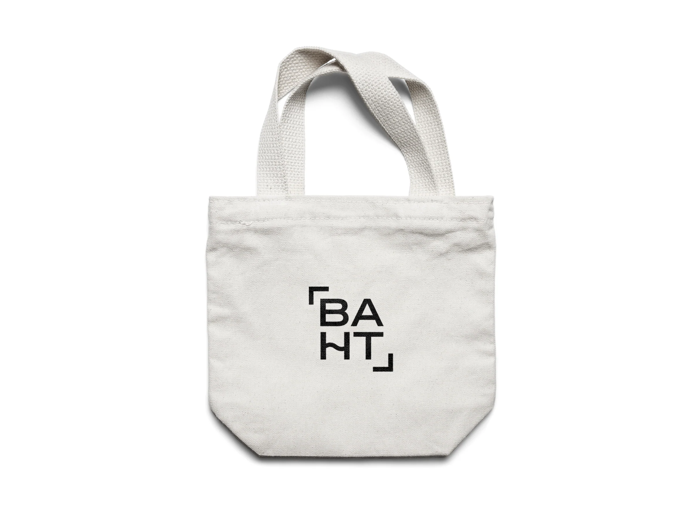 Off-white canvas tote bag with the black baht logo printed on the front.