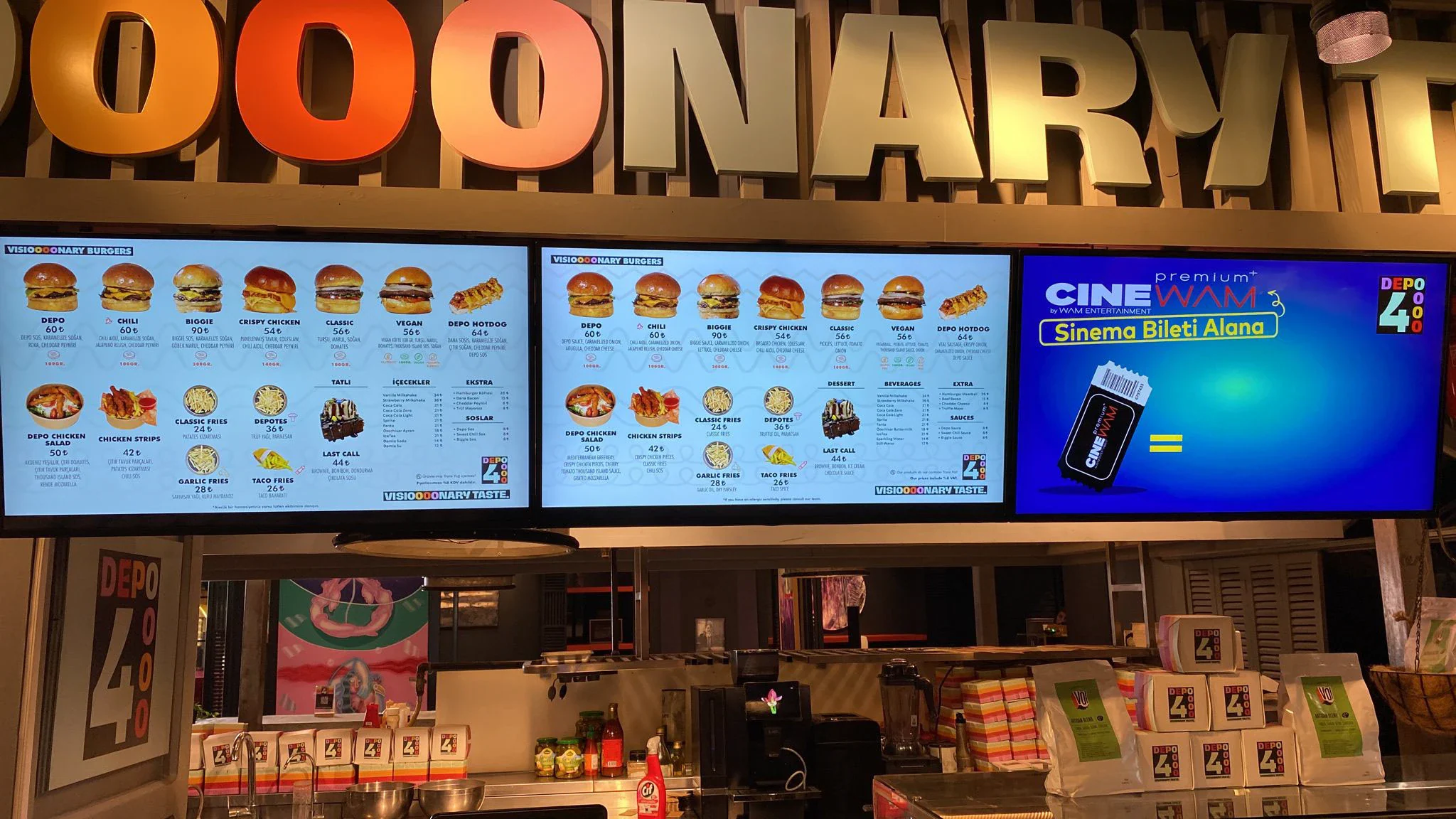 Three screens above the counter: two light blue Depo4 burger menus and a CineWAM cinema-ticket promotion carrying the Depo4 logo.