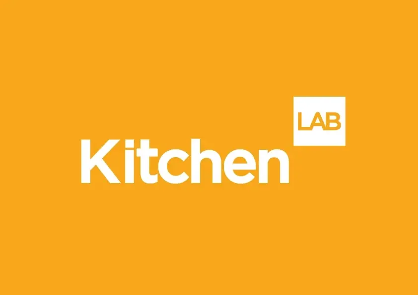 Animated KitchenLAB logo cycling through three colourways: white on orange, black on white with an orange LAB box, and white on black.