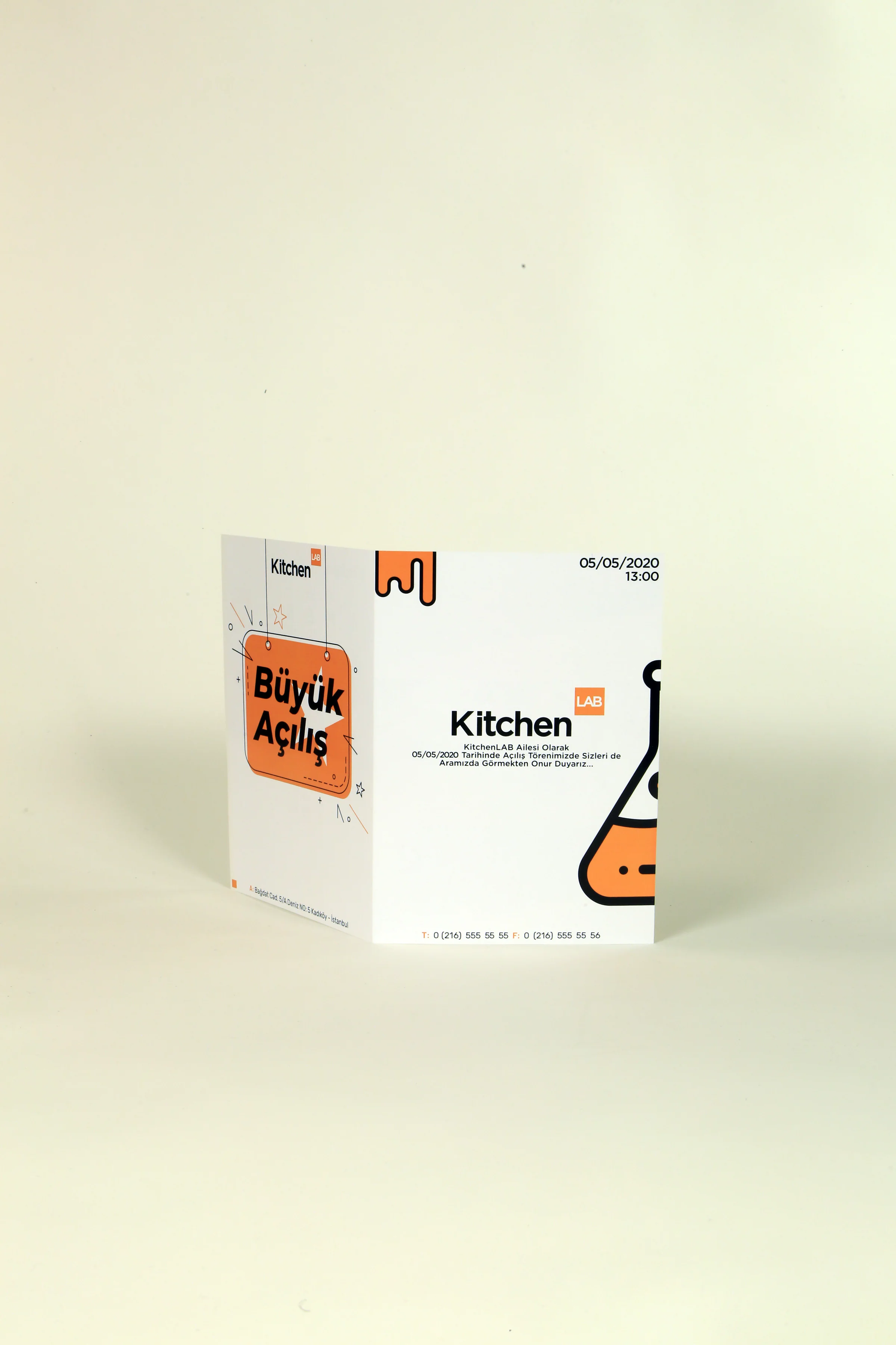 Folded Büyük Açılış opening invitation with an orange sign illustration, a flask graphic and the date 05/05/2020, 13:00.
