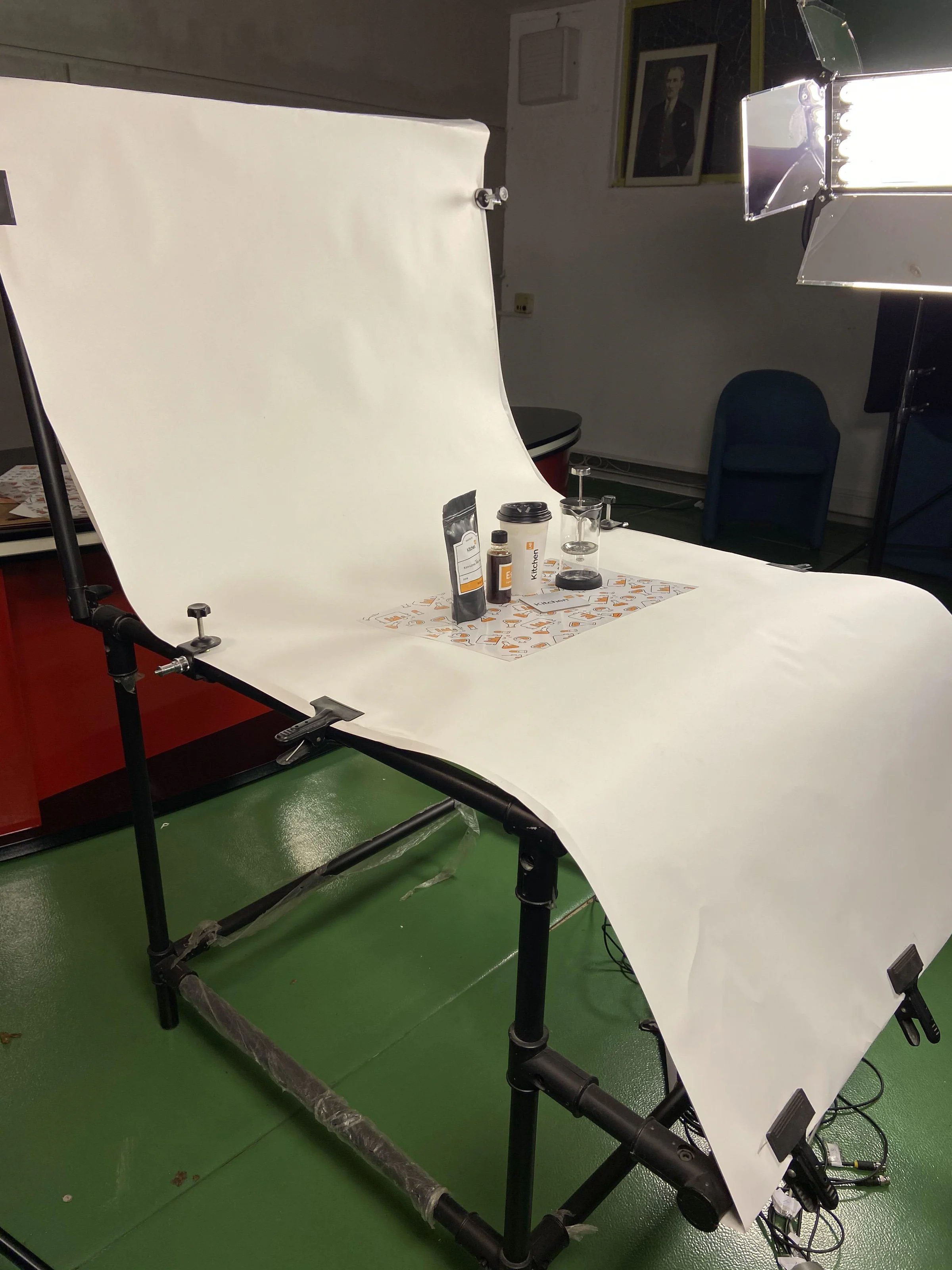 Backstage: the KitchenLAB coffee set on a white paper sweep over a shooting table, lit by a studio LED panel.